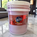 White bucket labeled 'Premium Power Degreaser' on a marble floor.